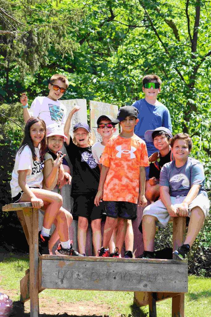 Day Camping in 2025. A group of children standing on a big chair.