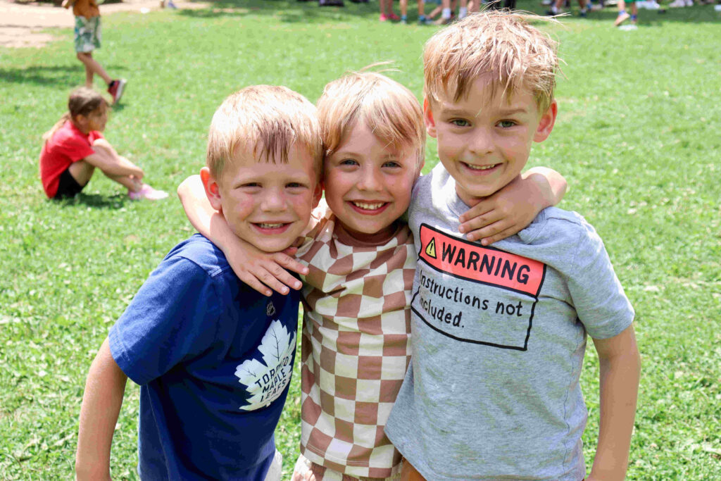 Day Camp. Group of Children with arms wrapped around each other during day camp.