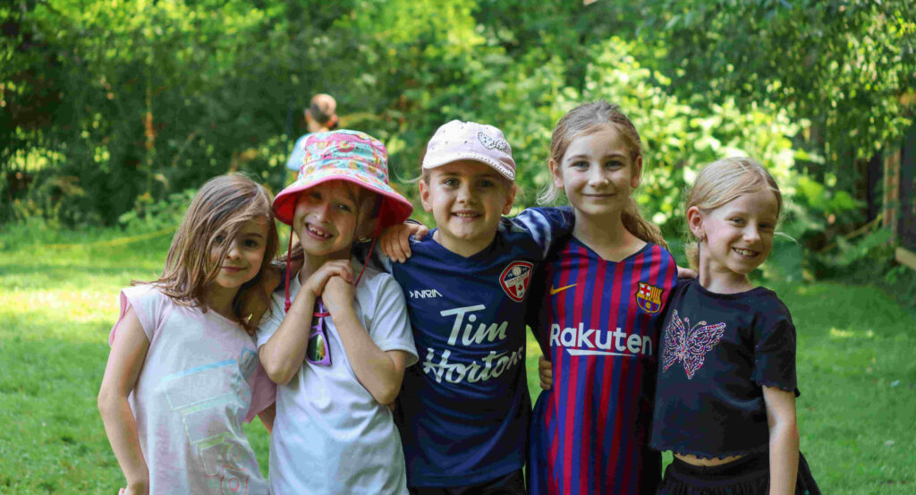 day camp. grow, learn, and make lasting memories. Girls standing in a group.