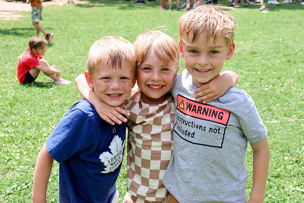 Adventure Valley. Children standing together in a hug.